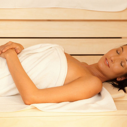 A lady enjoying sauna wrap in a women's spa in a spa in Charlotte